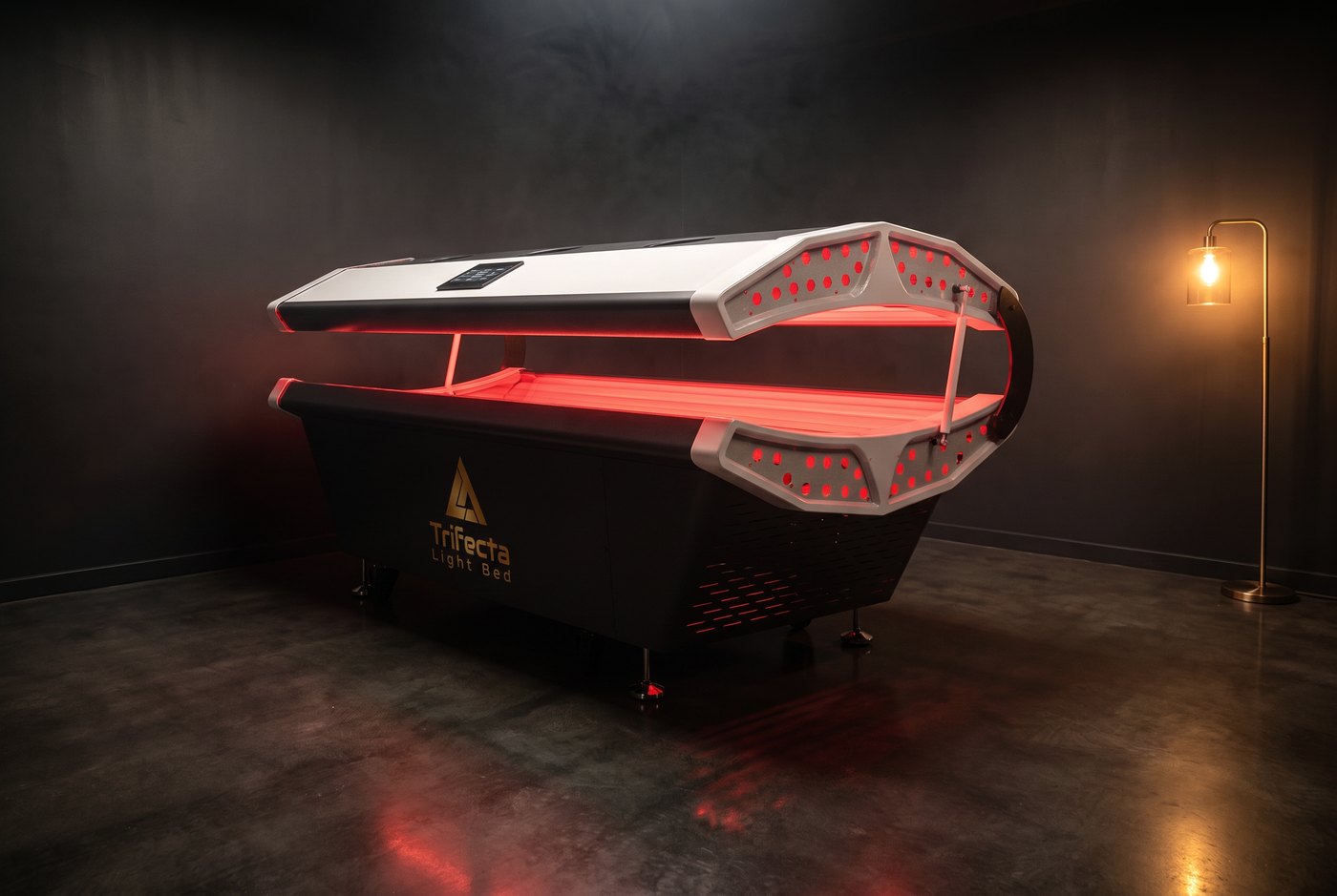 The Trifecta Light Bed glowing red in a dark studio