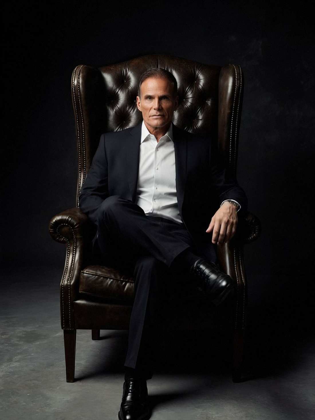 Mike Torchia seated in a leather wingback chair